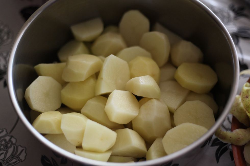 Peel and cut all the potatoes into small pieces like this. You can cut as small or big as you like, we will be mashing it all anyway. Smaller pieces, faster cooking. Genius huh!