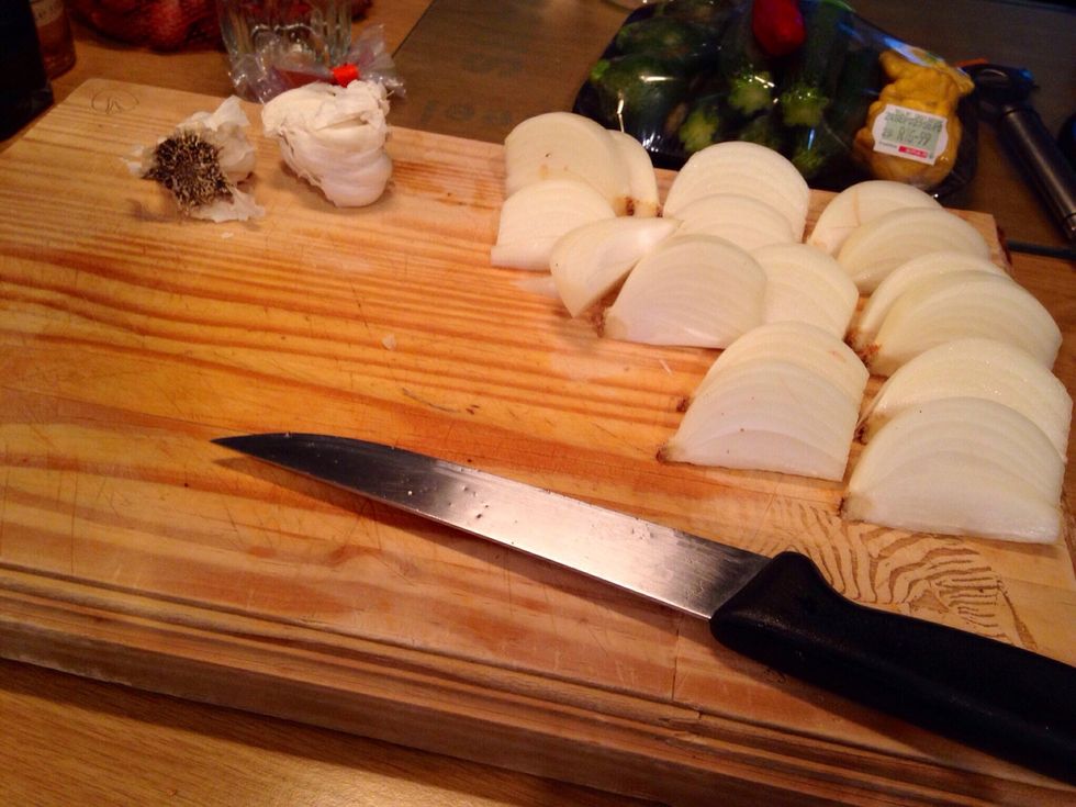 Peel and cut onions into large wedges, try keeping at least one point intact so they don't fall apart when cooking.