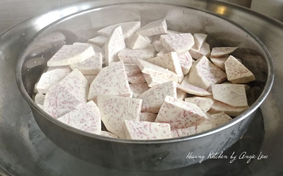Peel and cut yam into slices. Steam the yam till very soft and cooked, about 30 minutes.