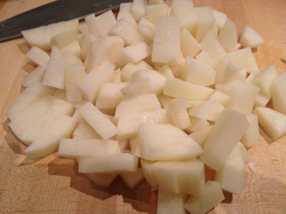 Peel and dice the potatoes.