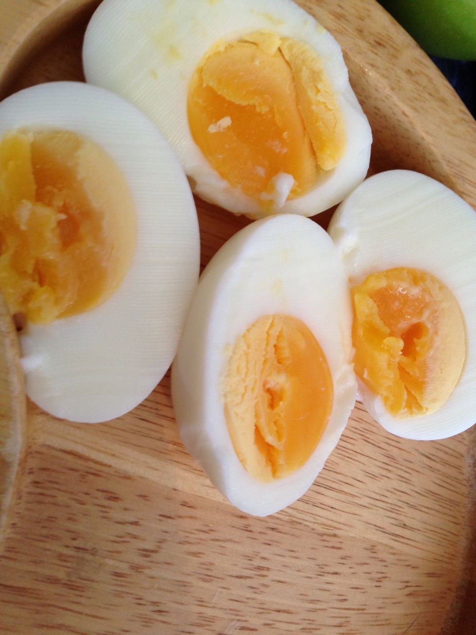 Peel and slice the boiled eggs