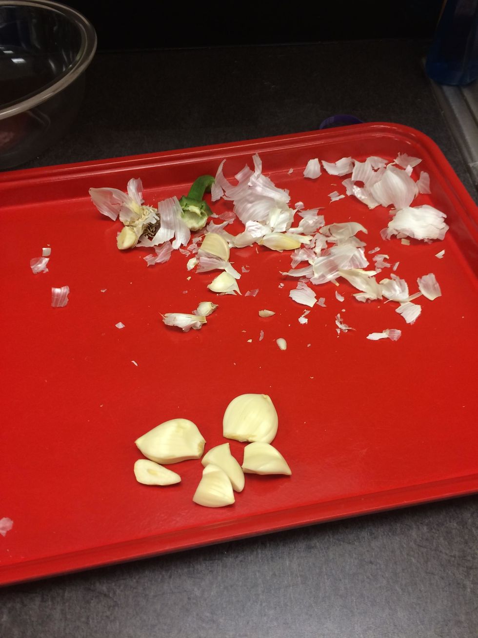 Peel and split the two cloves of garlic