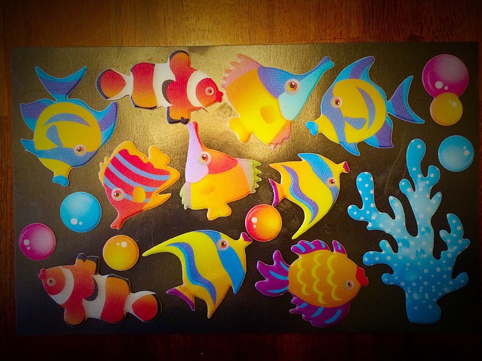 Peel and stick a set of fun stickers onto the sticky side of the magnet sheet. These ones are slightly puffy with a rough texture which makes them easier to move around. I found them at dollar tree.