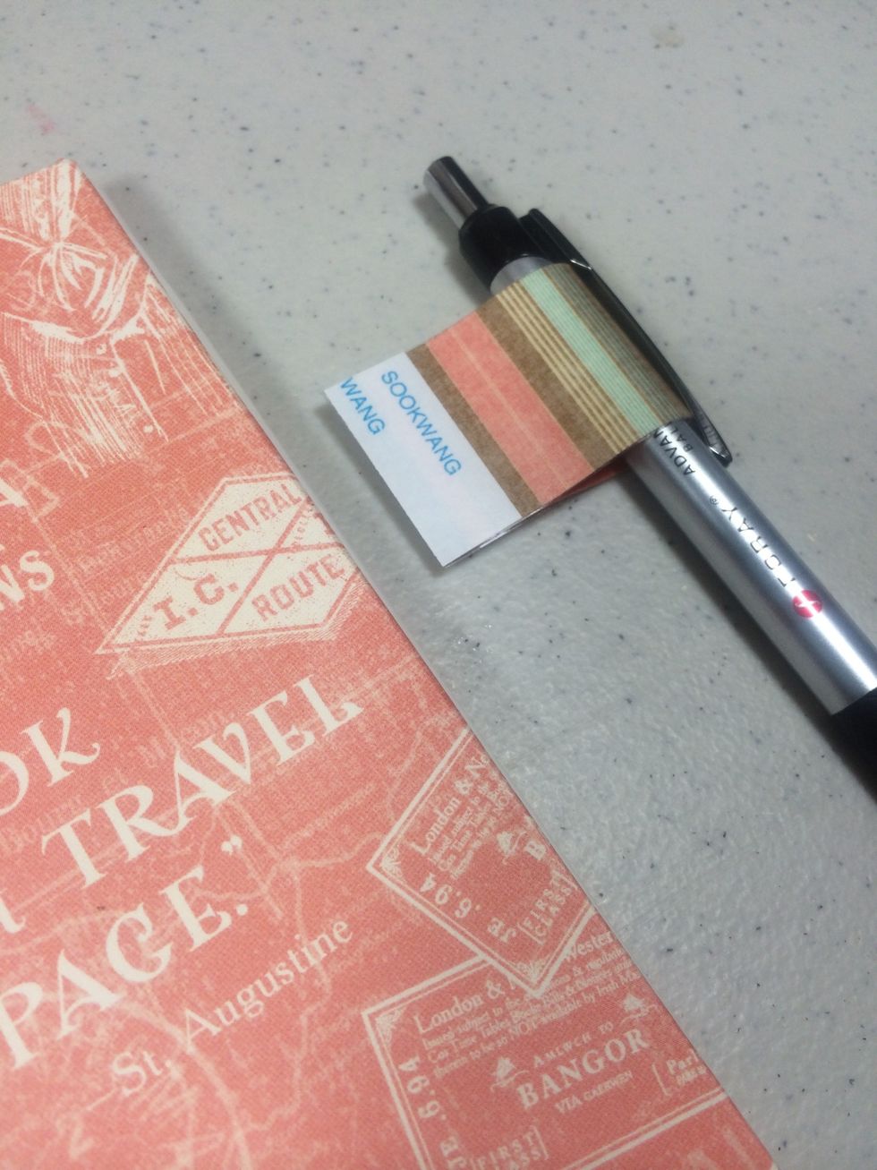 Peel and stick the holder in place to the inside of the front cover panel. Leaving the pen in the paper holder helps to get the positioning right.