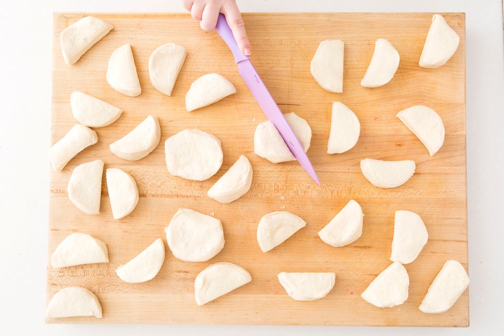 Peel apart your biscuits and cut each one in half.