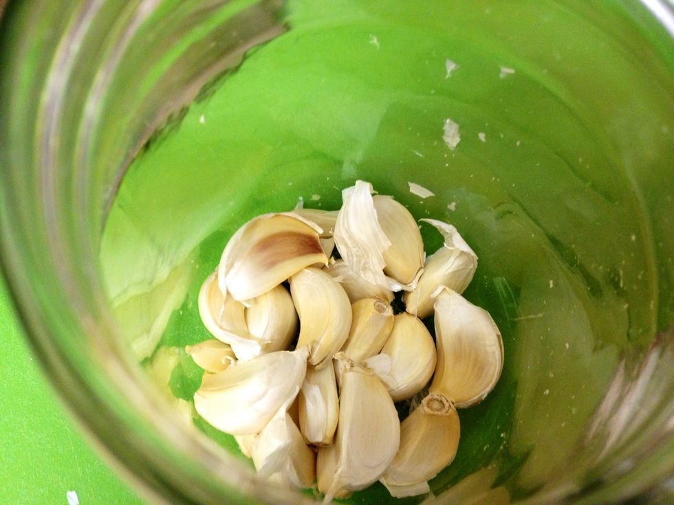 Peel away the outside paper encasing the head and discard and then add your unpeeled cloves to a jar. Close the lid tight and shake vigorously for 20-30 seconds.