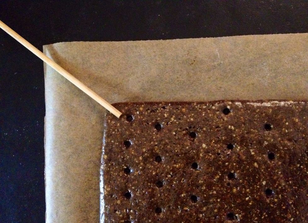 Peel away top paper and dock dough (make numerous tiny equi-distant holes on surface) with a docking tool. Or you could also use a wooden stick.