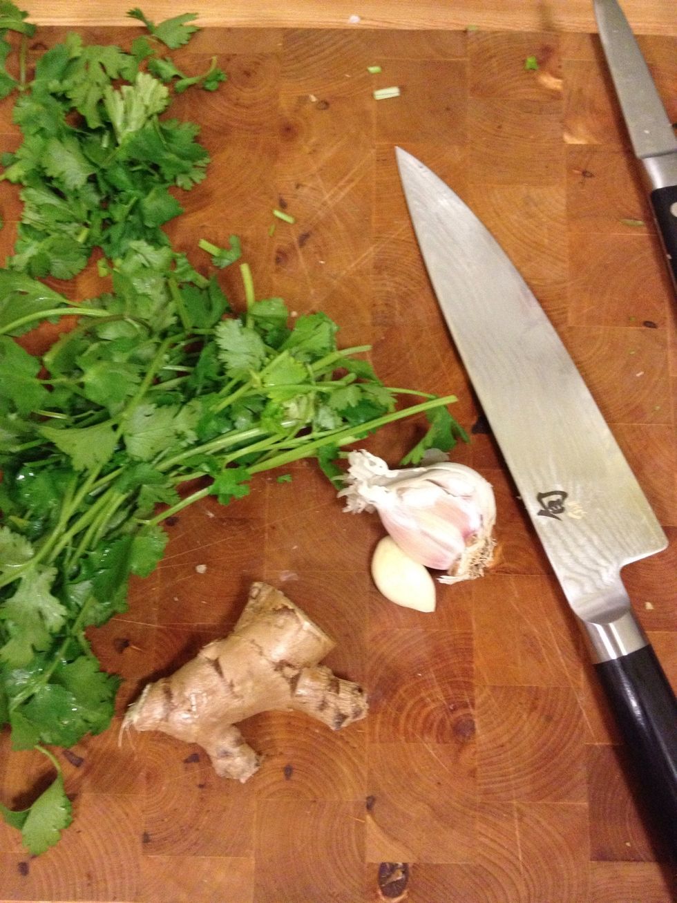 Peel Chop 3 cloves of garlic and a thumb sized piece of ginger root small bunch of cilantro stalks.