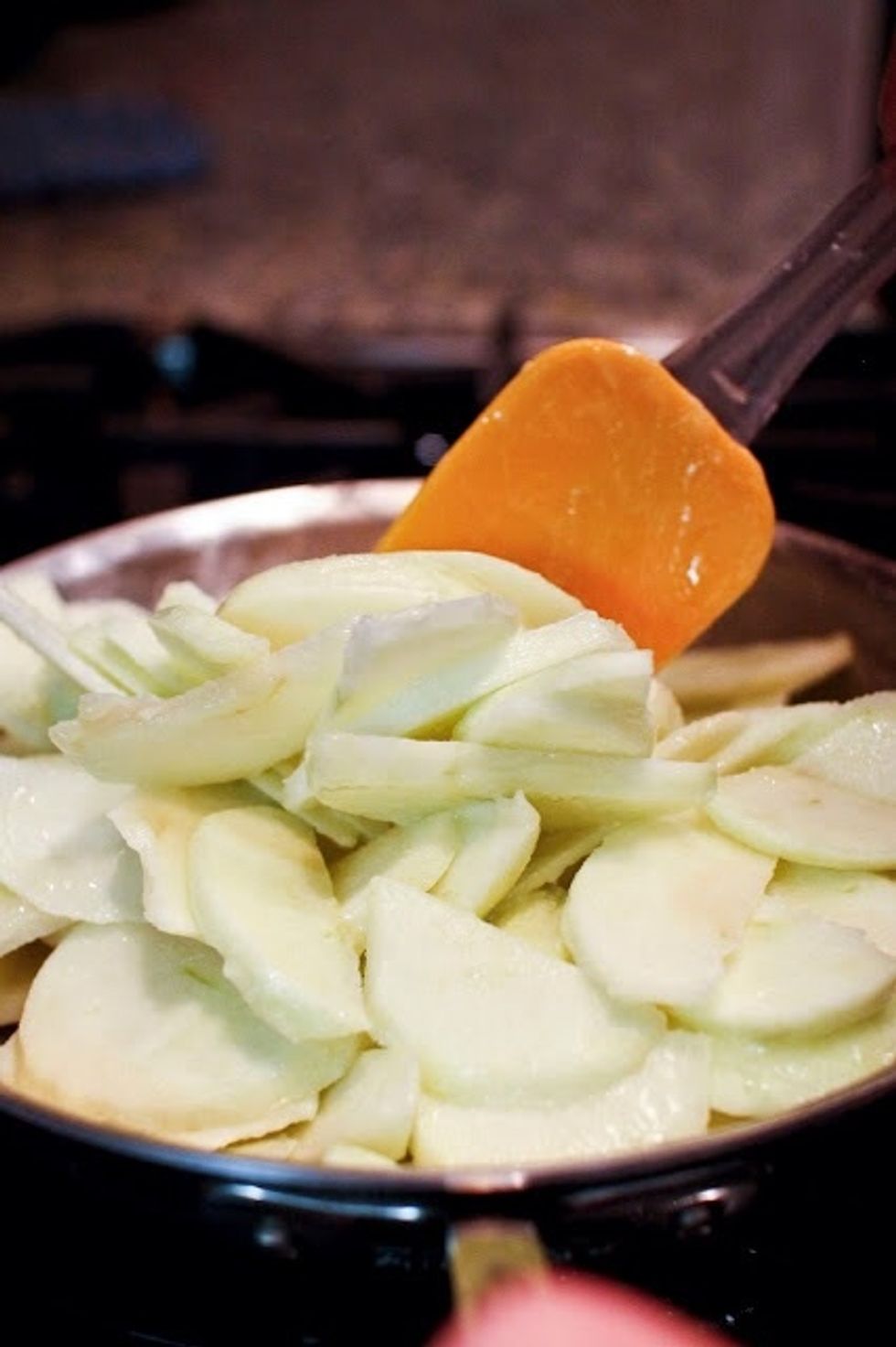Peel, core, and slice the apples into the melted butter. The trick here is to get them into the butter so that they don't start to oxidize and turn brown.