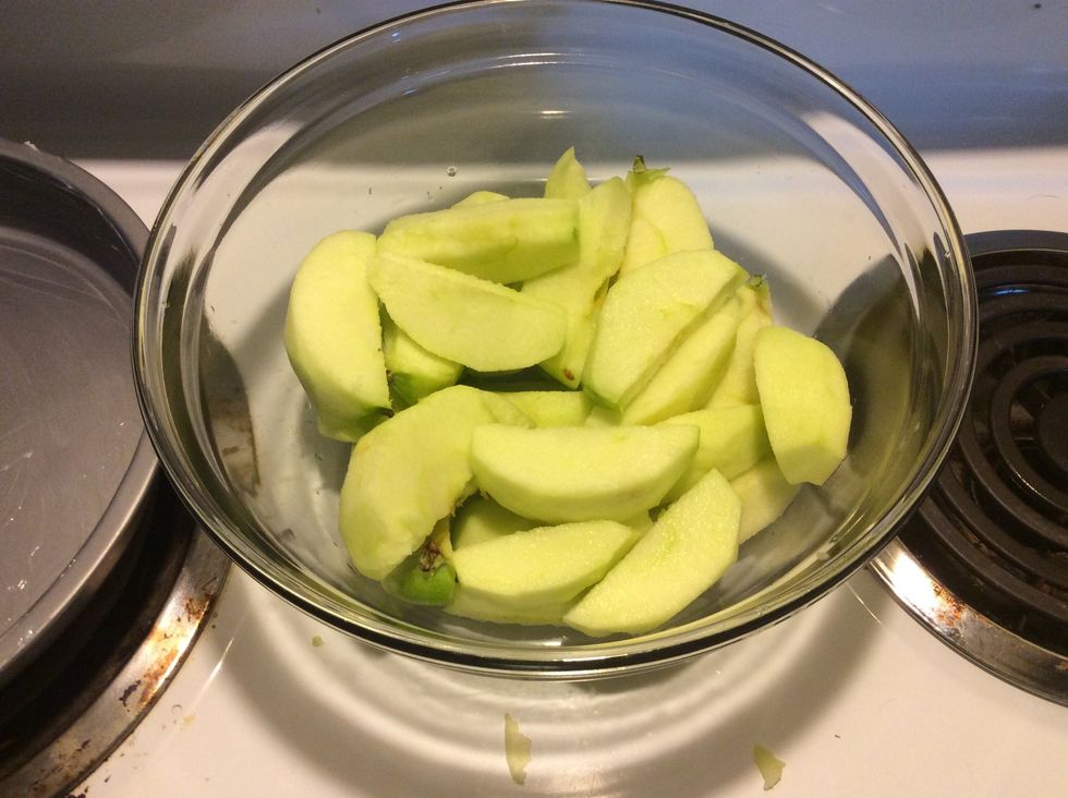 Peel, core, and slice the cooking apples and place them in a bowl
