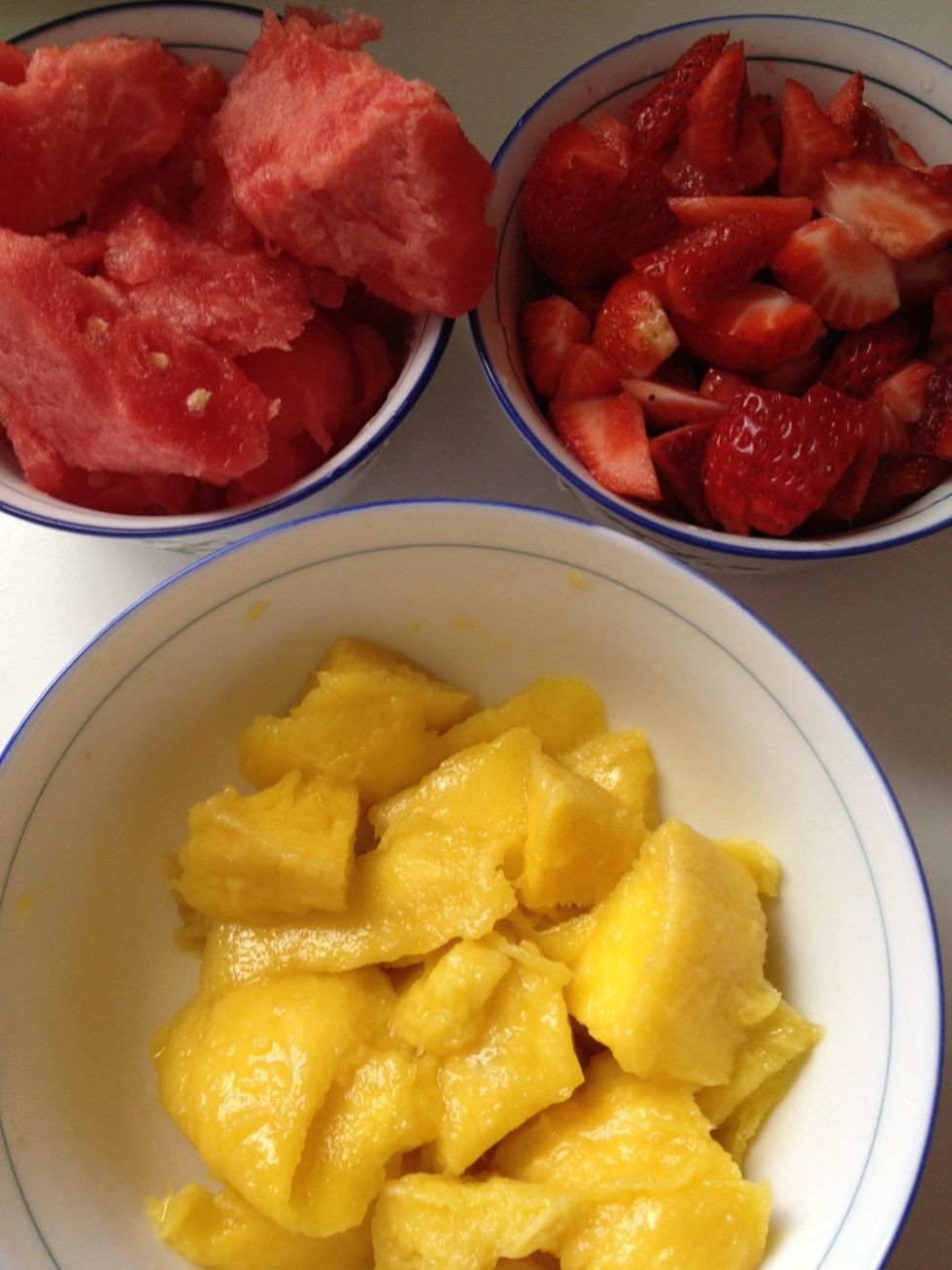 Peel & cut your mango. Scoop/cut out watermelon. & slice the strawberries.