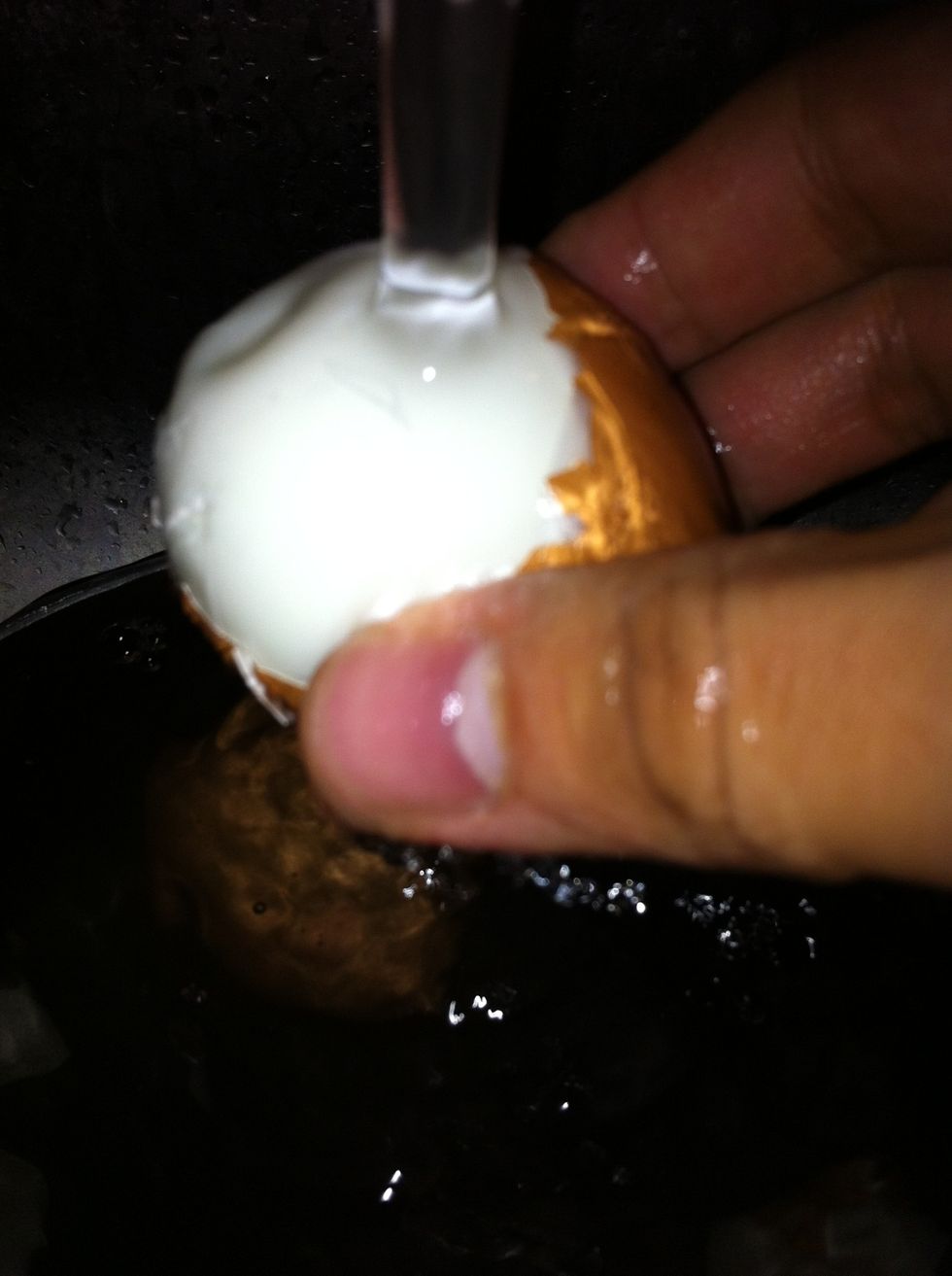Peel egg shells. Easier to do when starting from the bottom (crack it at bottom because there is a little hollow spot there) and under water.