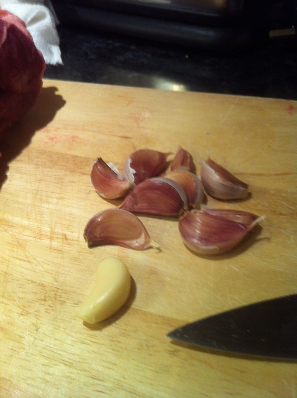 Peel four cloves of garlic and leave four unpeeled