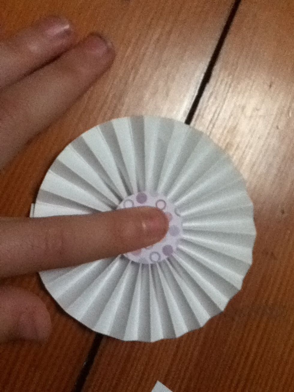 Peel off the backing of the double sided tape if it has a backing, and put it in the middle of your flattened ring to hold it in place.