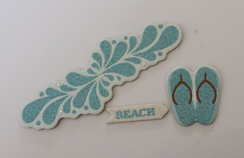 Peel off the glitter waves from one of the Chipboard Layered stickers. Also take the flip flops and the Beach chipboard piece from the Layered Chipboard package.
