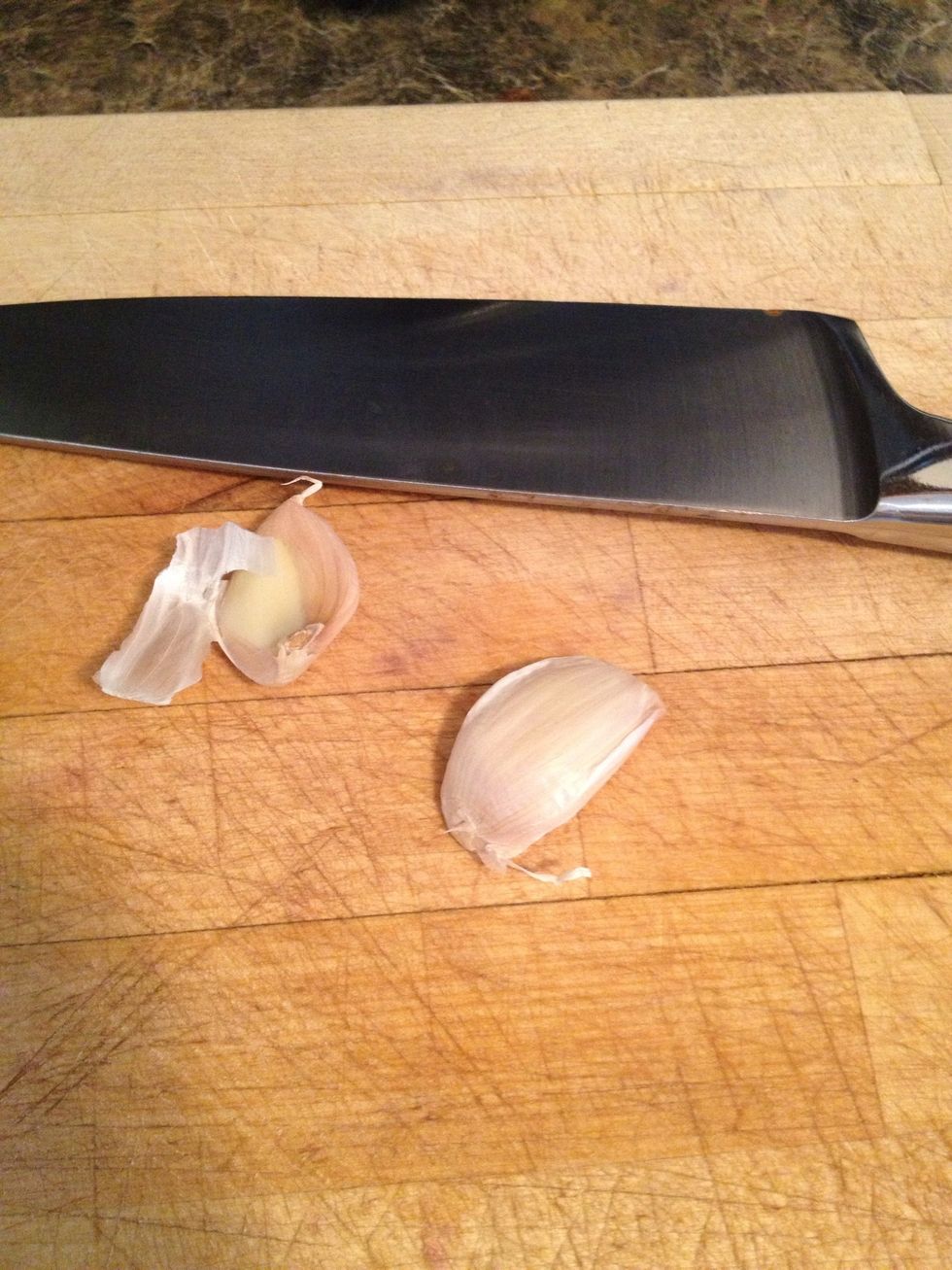 Peel off the outer paper from the 2 garlic cloves. Its easier by cutting off both ends and smashing the garlic slightly with the side of the knife blade or bottom of a measuring cup if you feel safer.