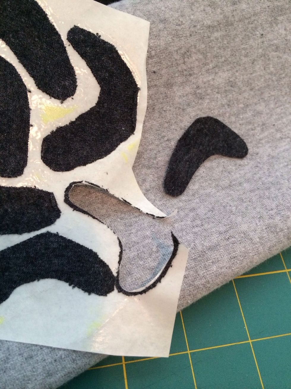 Peel off the paper and then cut out the shapes with nicer edges (which is actually possible this way).