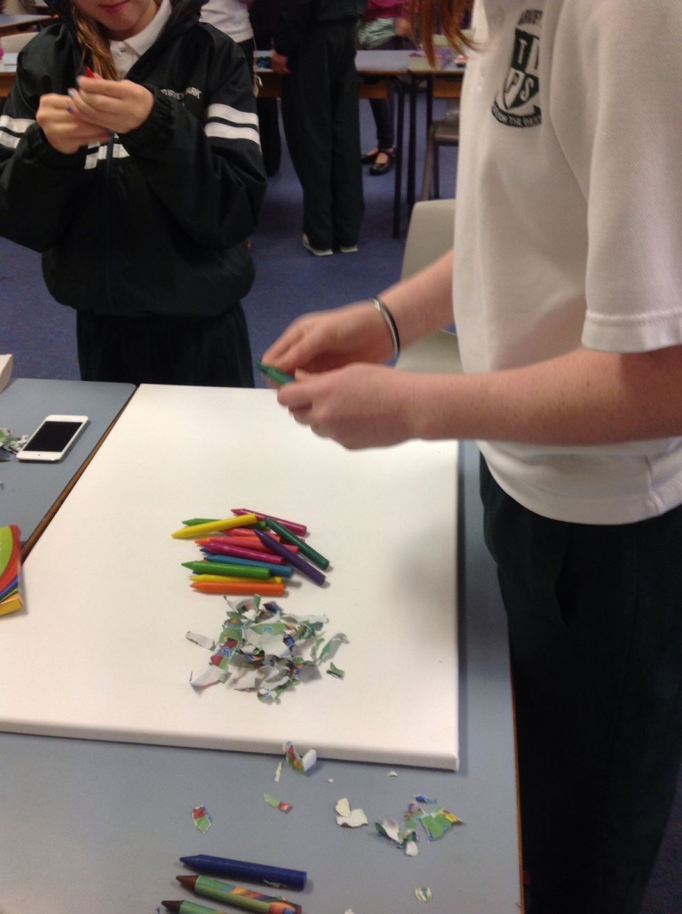 Peel off the paper off the crayons to give it more effect
