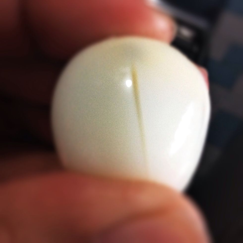 Peel off the skin when they are cool enough. Make some slits to avoid 'egg explosion' when frying