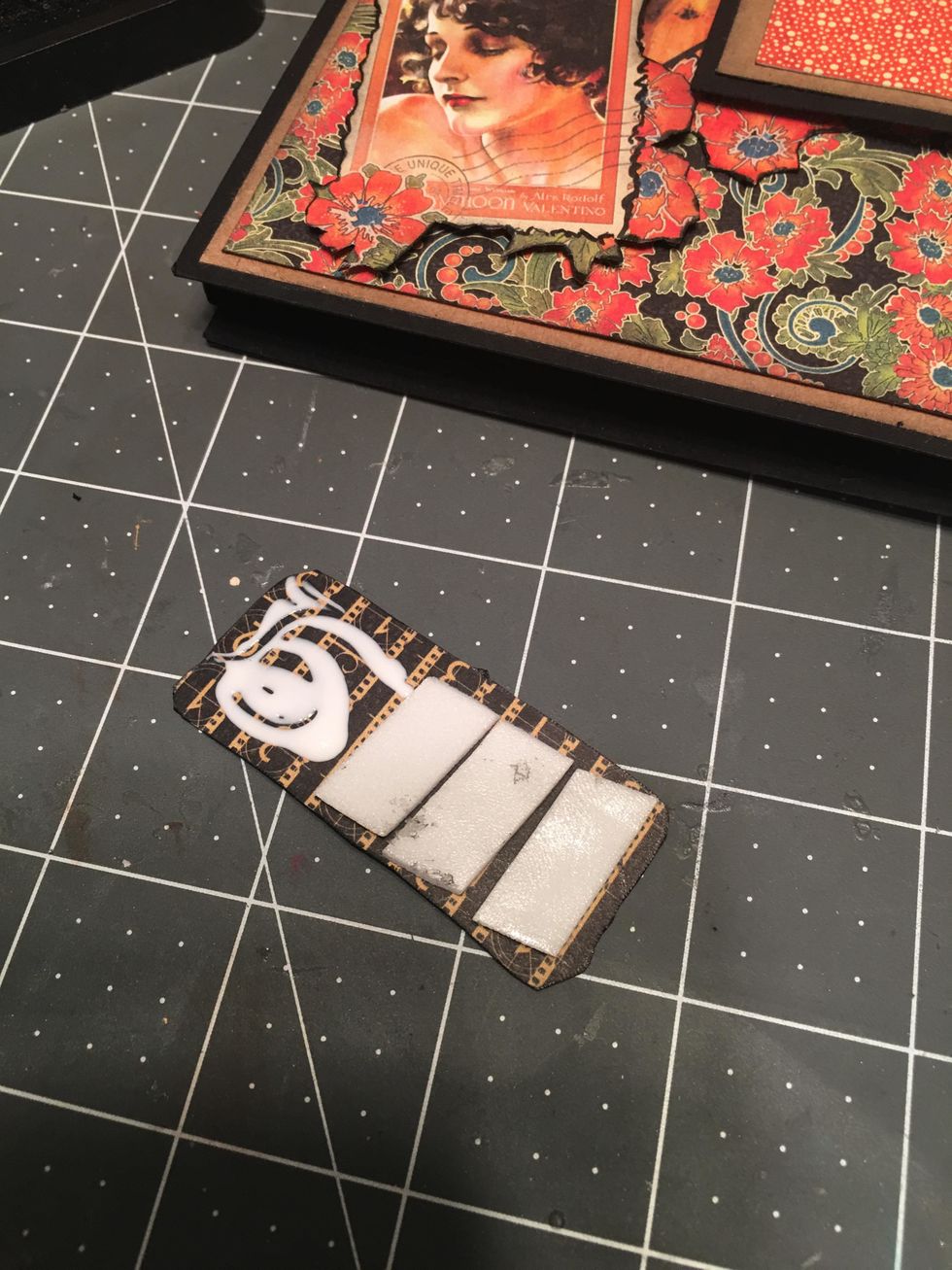 Peel off the tape backing and add glue to the back left side.