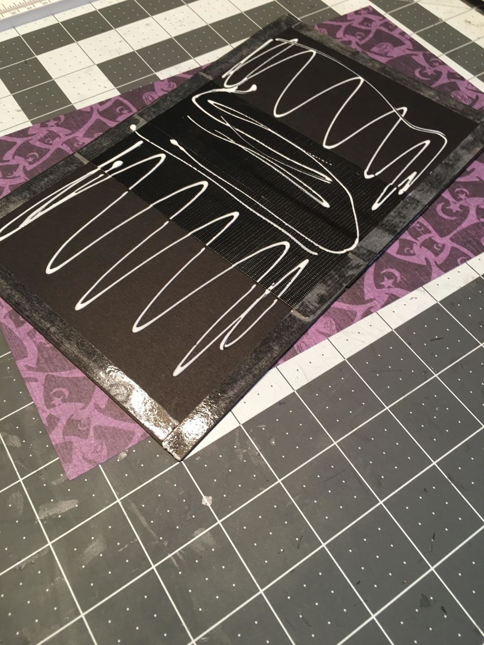 Peel off the tape backing and apply glue to the rest of the areas of the cardstock cover.