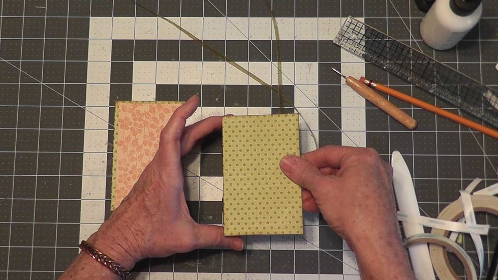 Peel off the tape backing and attach a cover to the box.  The cover needs to be flush with the edge of the box on the hinge side and centered top to bottom.  Repeat for the other side.