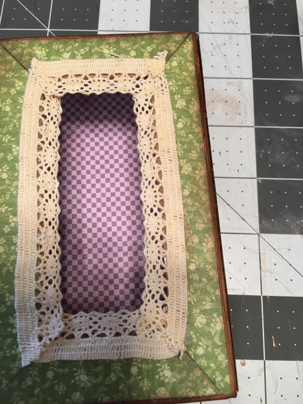 Peel off the tape backing and attach crochet lace around the edges of the opening as shown.