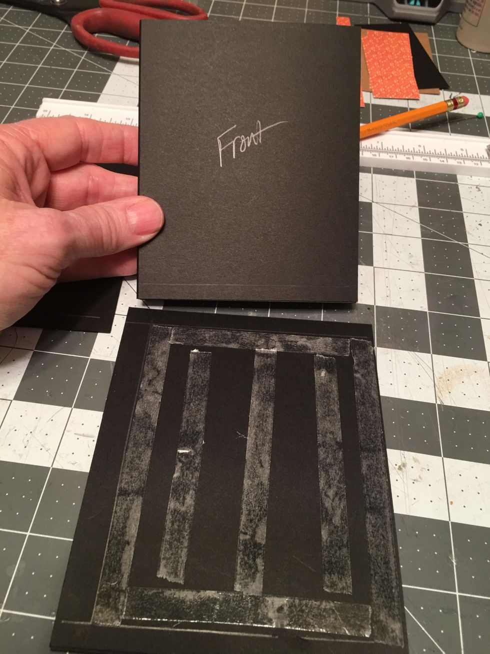 Peel off the tape backing &attach the front side of the pages to the front cover piece.Make sure the magnet will end up on the front right edge when attached.This part is tricky, carefully line it up.