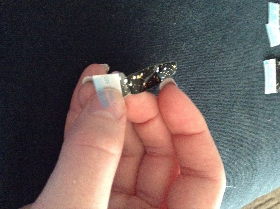 Peel off the top plastic layer, then take the strip off the paper back.