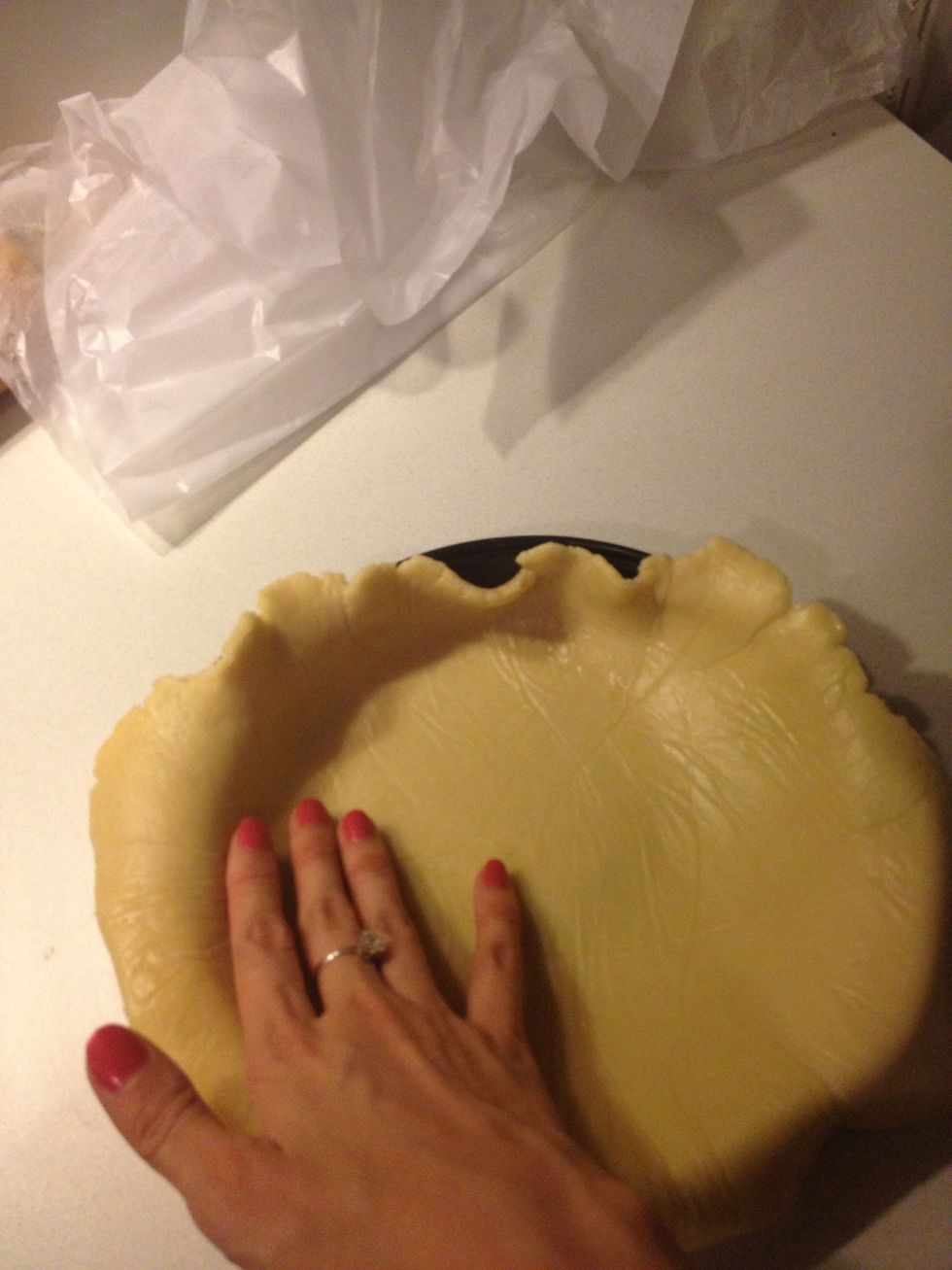 Peel off the wax paper and fit the dough into the pan.