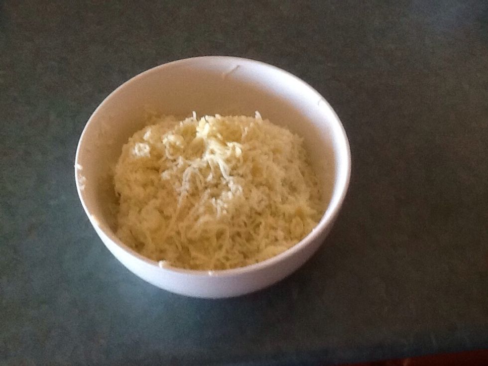Peel potatoes while still hot and and put them in a potato press