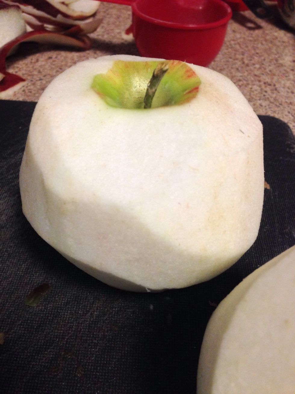 Peel skin off apples using either a knife or peeler. Save the skins because you can deep fry them later, top it with cinnamon sugar and makes for a great snack using the whole apple (nothing's wasted)