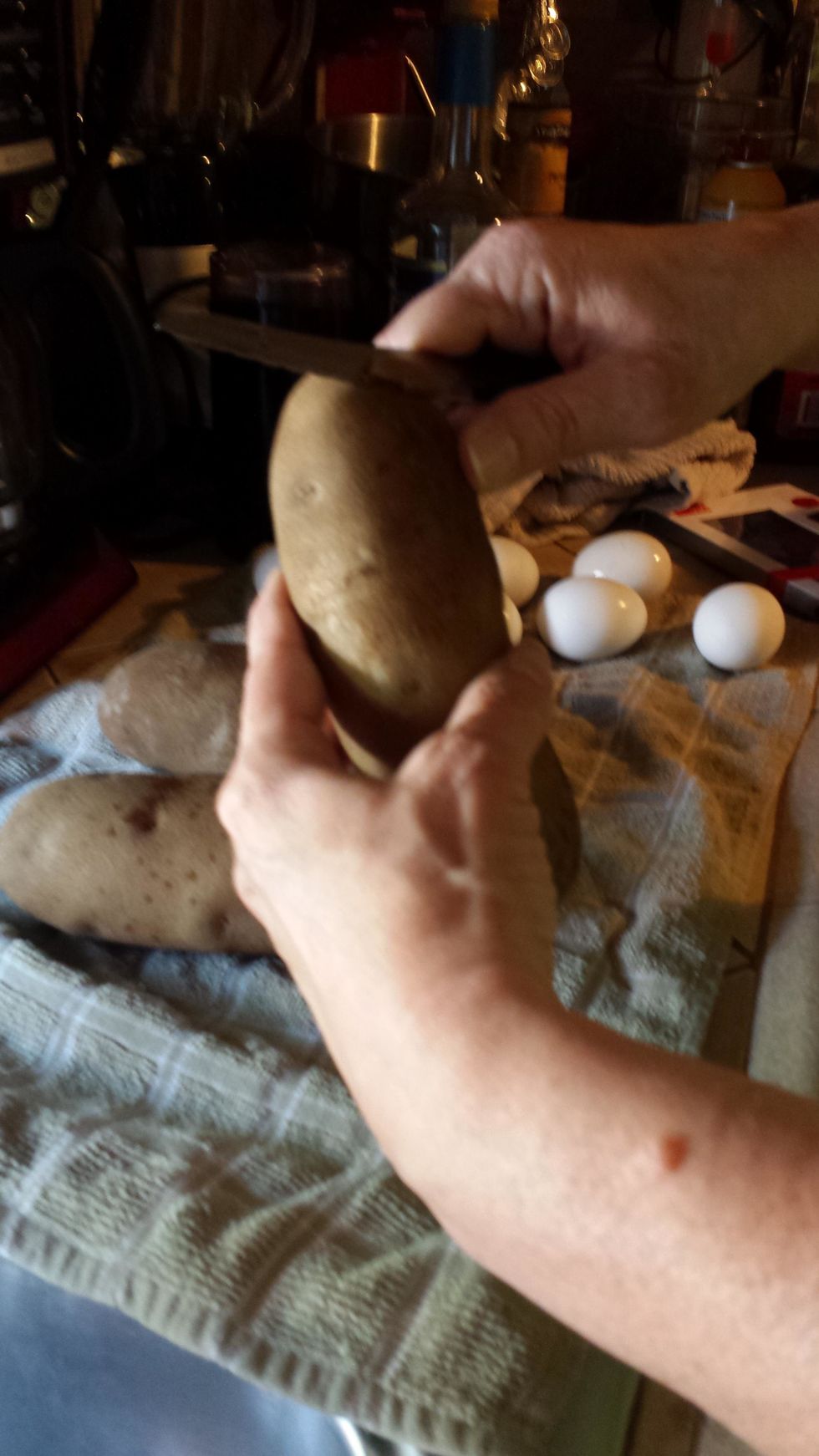 Peel the 3 large potatoes, cut them into small pieces, and add to the bowl.