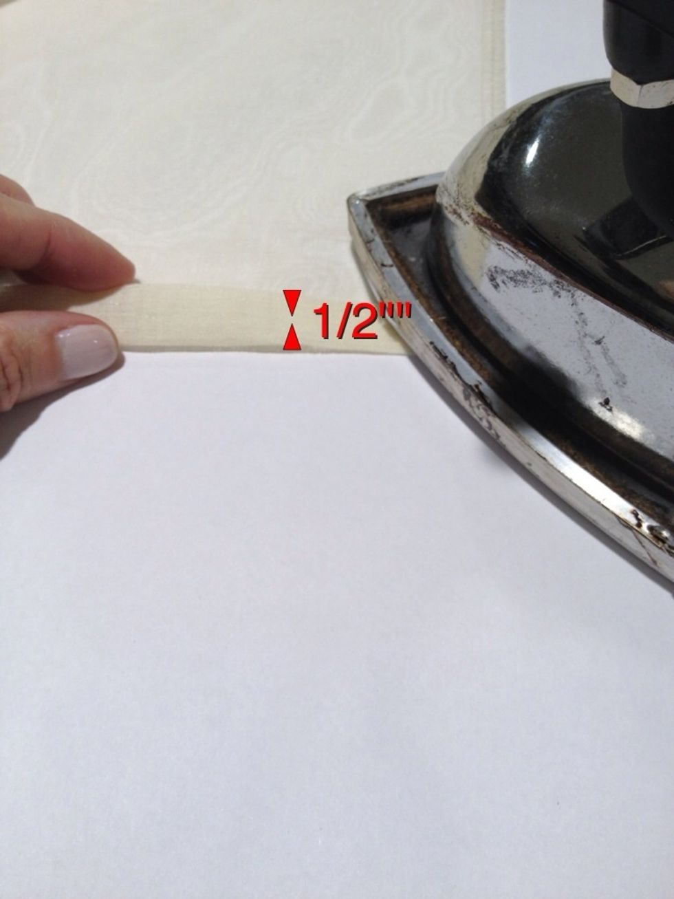 Peel the backing off the Steam-a-Seam. Turn up another 1/2" and press. This will form the bottom hem.