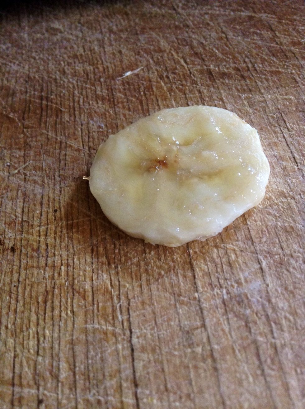 Peel the banana, and cut it into slim coins.