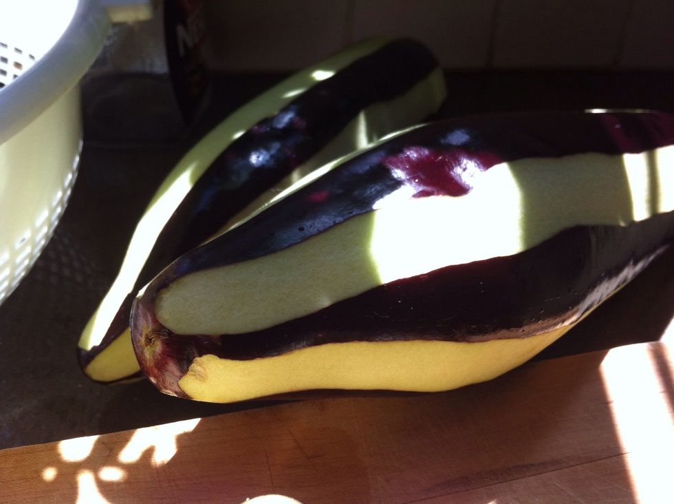 Peel the eggplants but leave strips