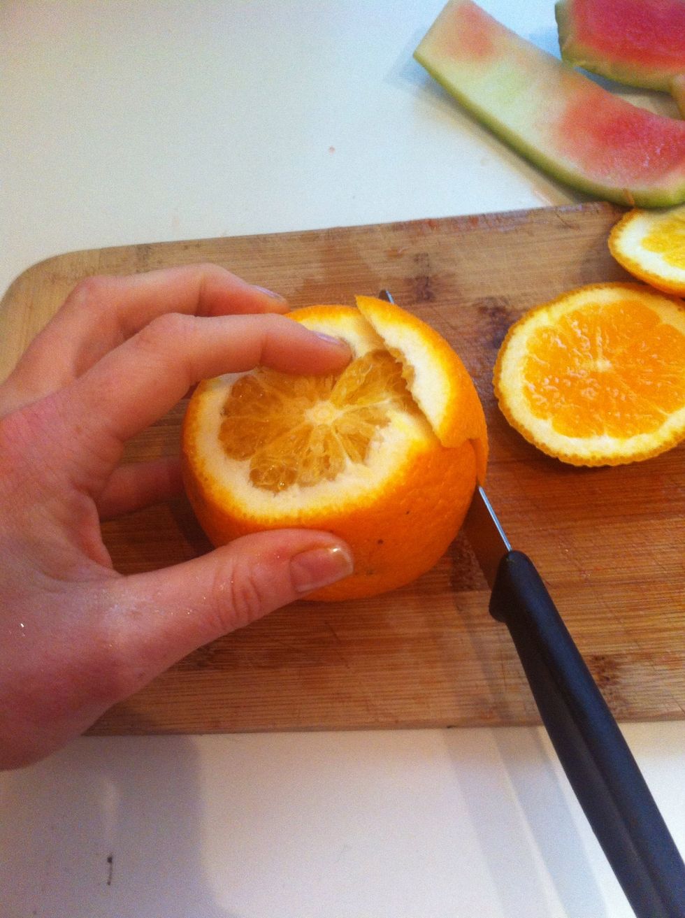 Peel the orange using a sawing action with your serrated knife and follow round the shape of the orange, you can also peel with your hands either way is fine!
