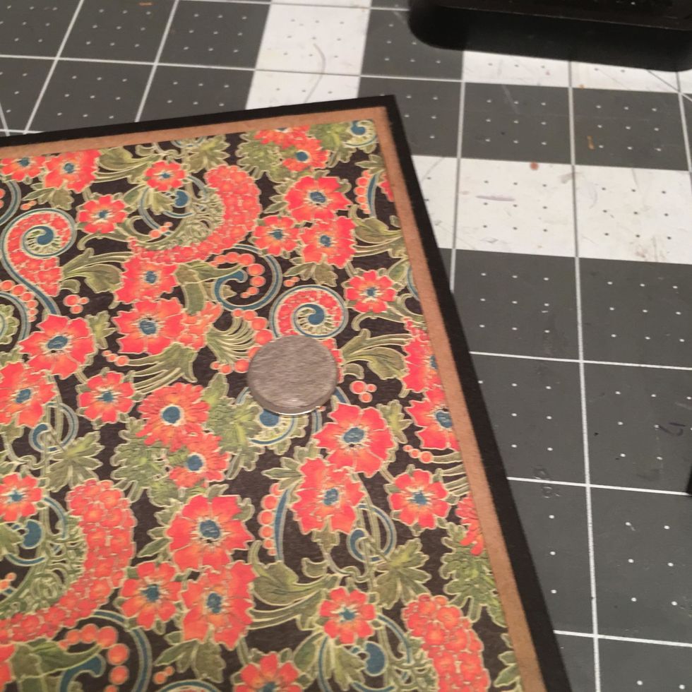 Peel the paper backing off of the magnet that is still attached (not glued) to the front album cover.