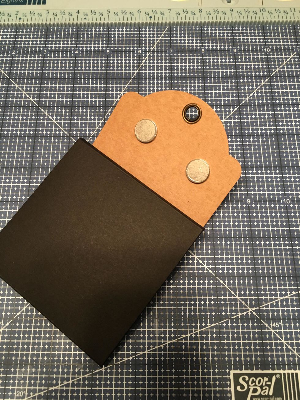 Peel the paper backing off of the minus magnets that are still attached by magnetism to the plus magnets.