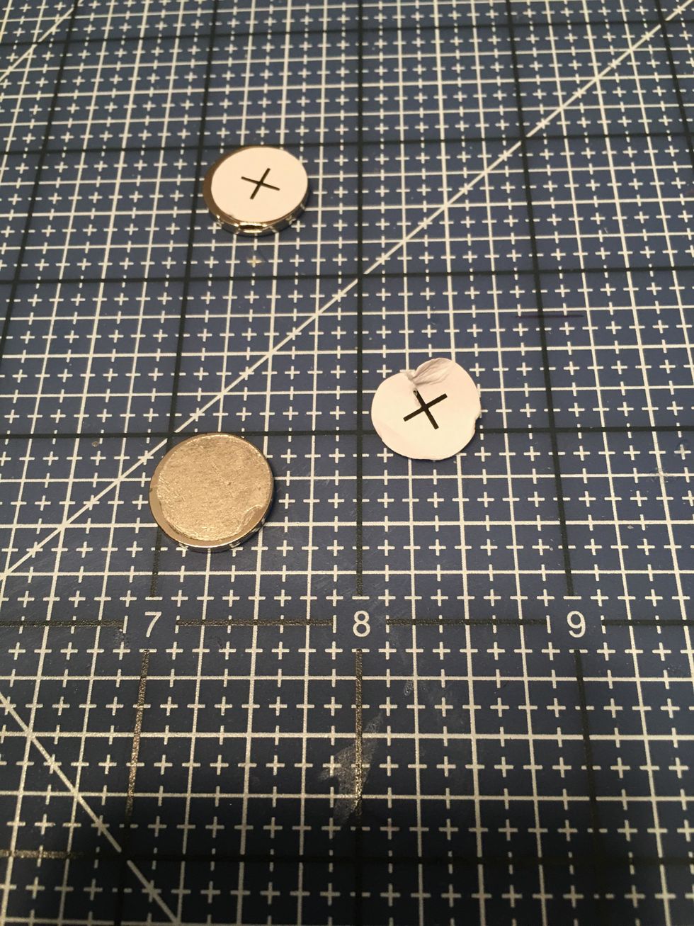 Peel the paper backing off of the plus side as shown.