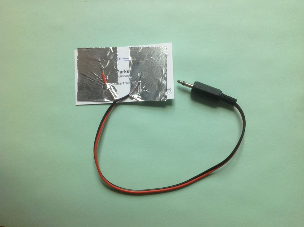Peel the paper from foil.  Stick down on left 1/2 of card.  Create tab by tearing the lower corner and stick 1 wire under so the exposed part of the wire is on top of the foil.  Repeat w/ right side.