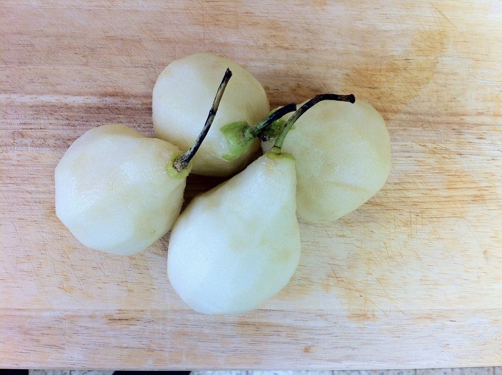 Peel the pears ( you can slice them if you like too , i like them whole )