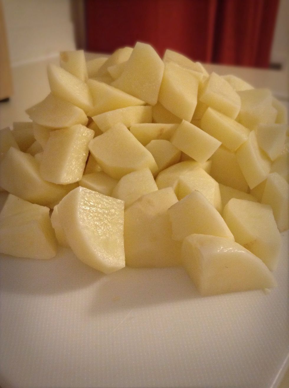 Peel the potatoes and chop them into large pieces.