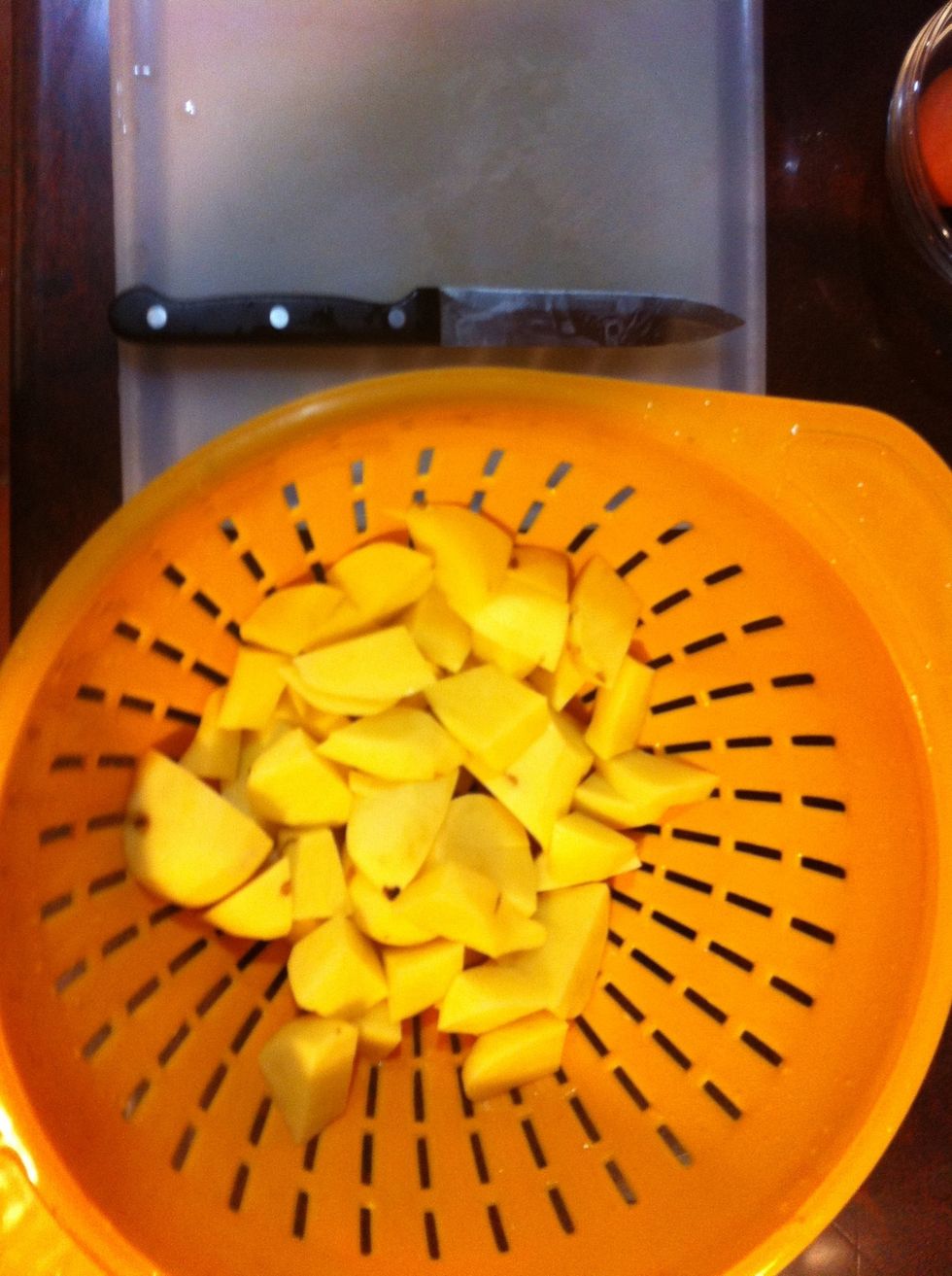 Peel the potatoes- cut into even cubes- boil them in a pot of salted water til fork tender- then strain.