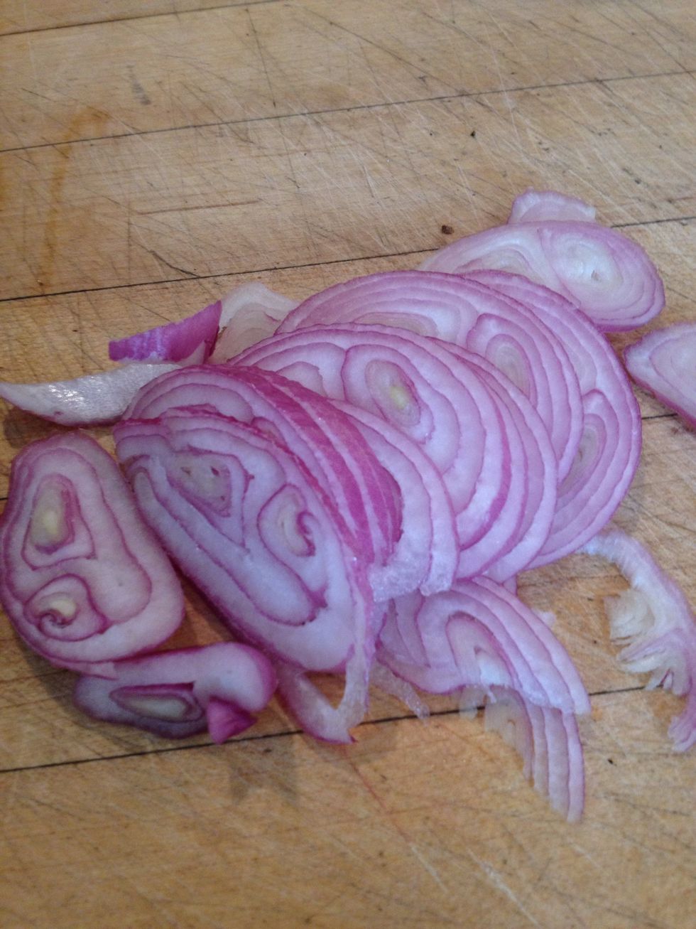 Peel the shallots and cut into very thin slices and add to the cucumbers.