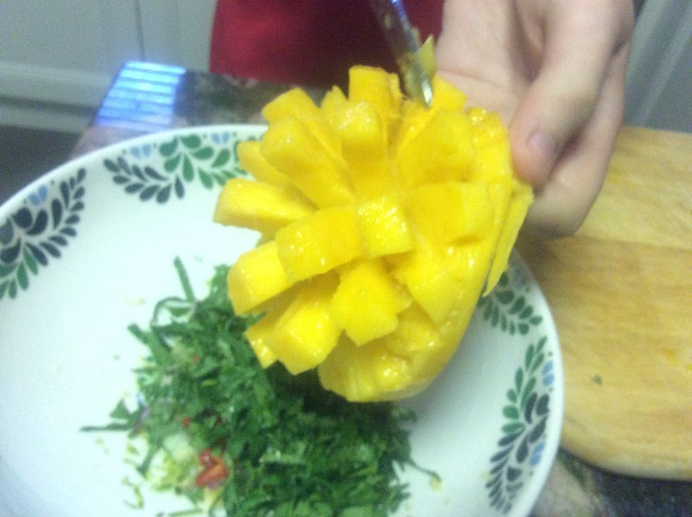 Peel the skin back leaving little cubes of mango