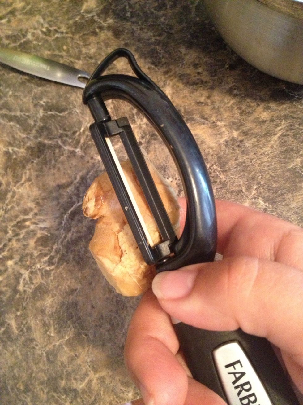 Peel the skin from a ginger root.