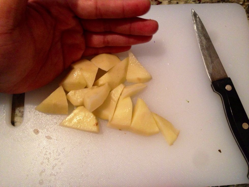 Peel the skin out of the potato and cut it up into chunks.