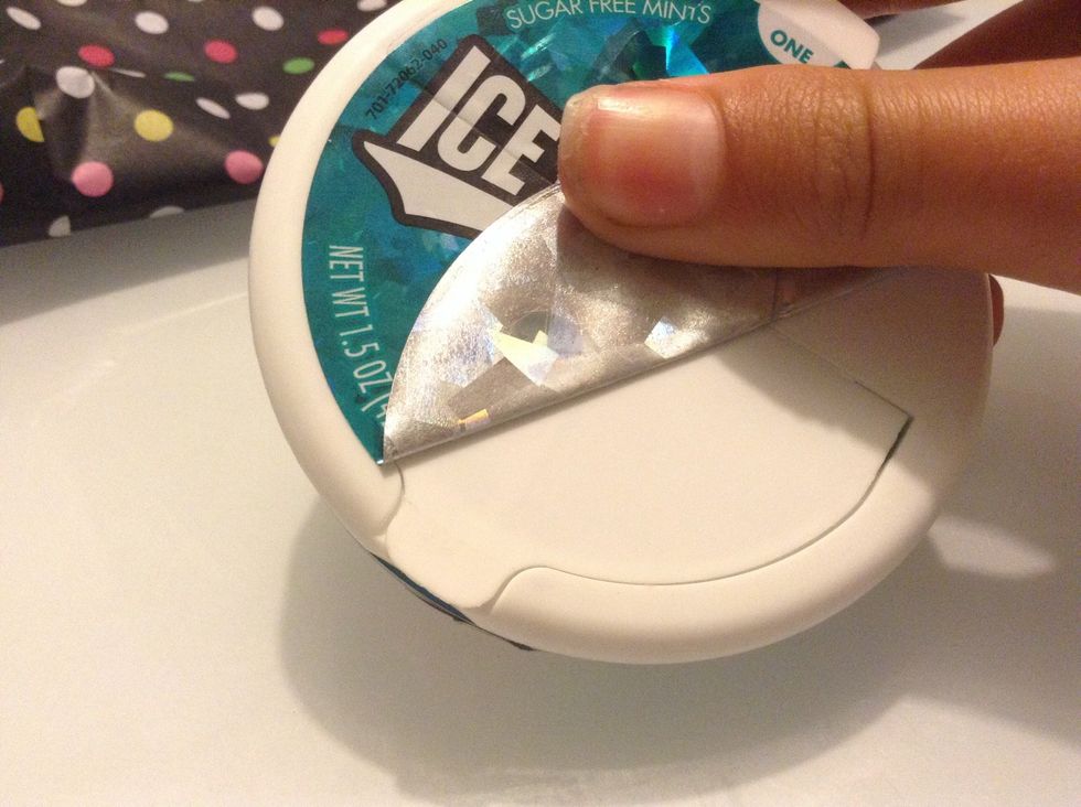 Peel the sticker off the top of the icebreakers box.