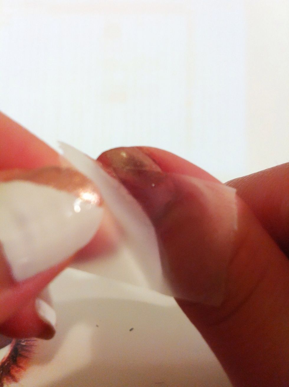 Peel the tap off when it is completely dried. Be careful on this step: when you peel off the tap, peel on the direction which towards the golden color polish, so the line will be straight enough.